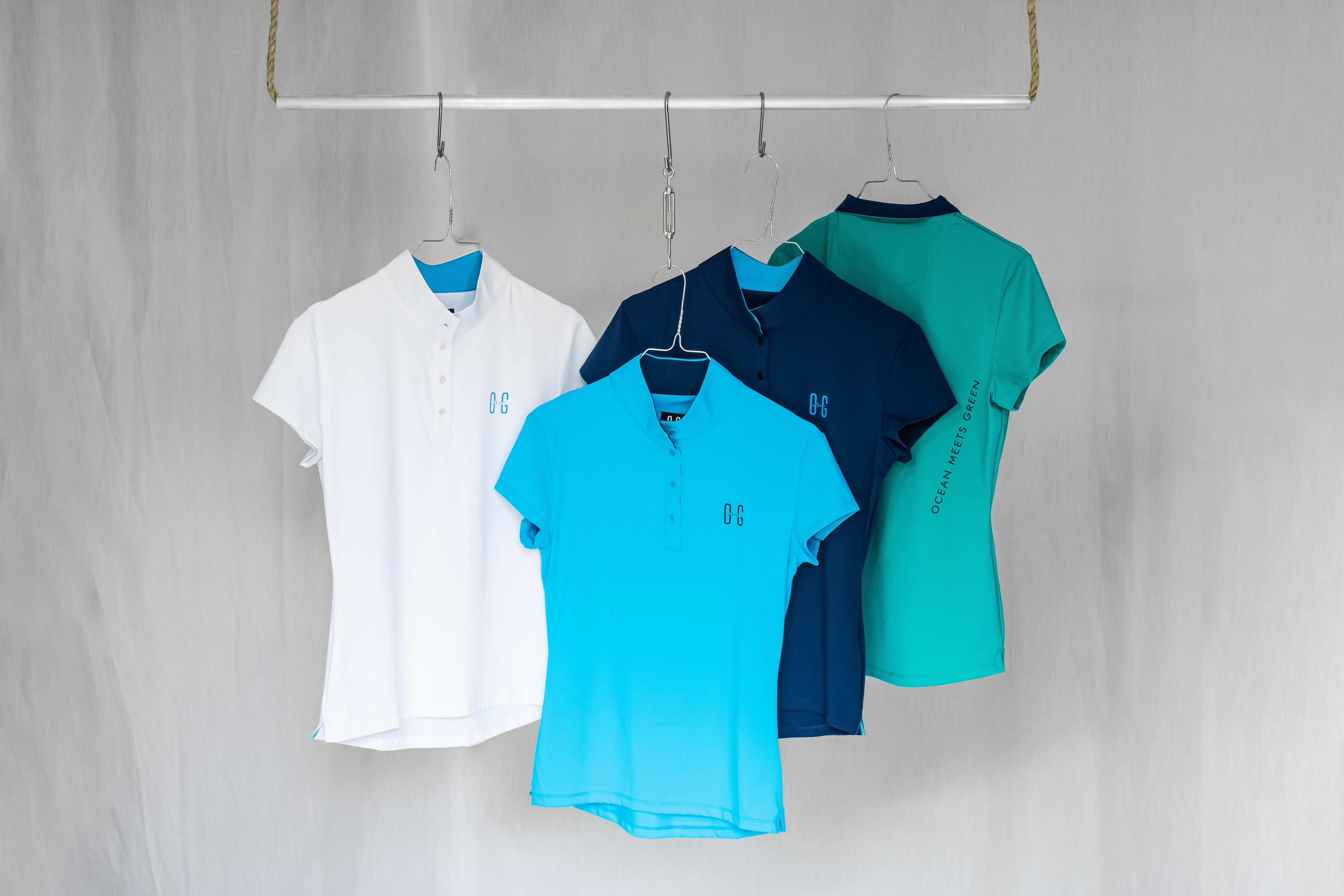 Women's golf polos presented on a hanger