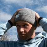 Ocean Meets Green Cloud beanie in grey, made from merino wool, worn by a male golfer