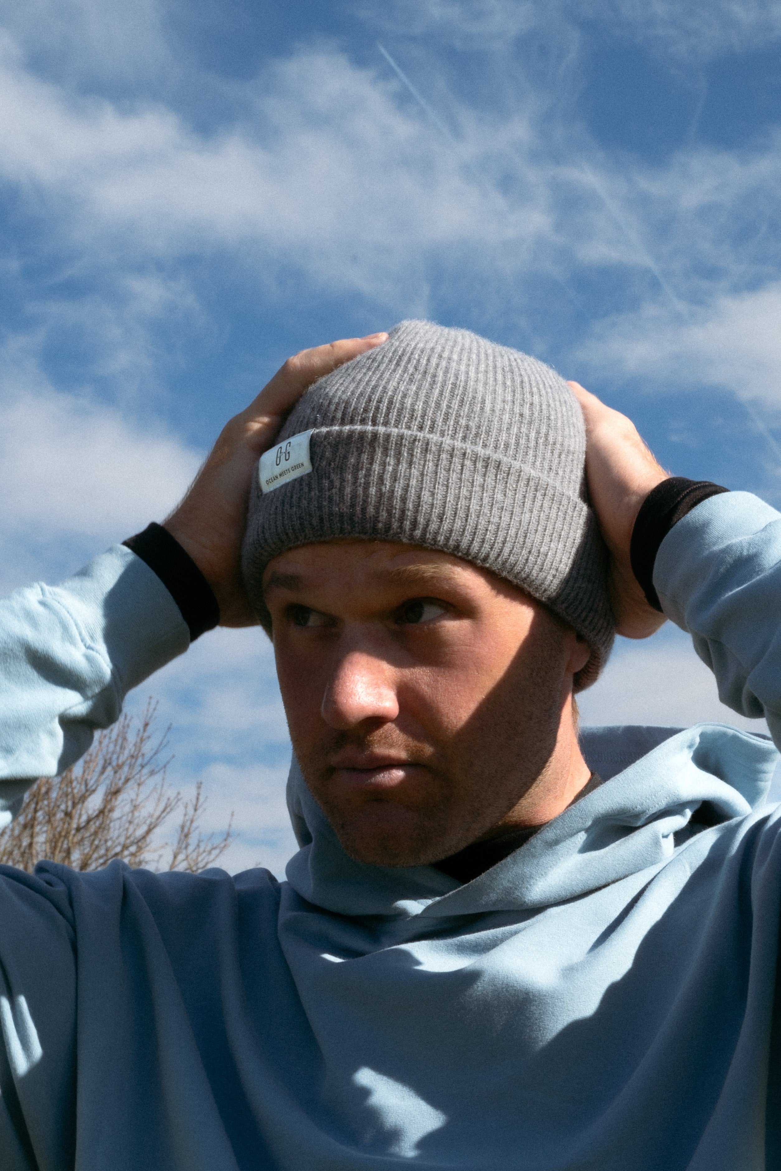Ocean Meets Green Cloud beanie in grey, made from merino wool, worn by a male golfer