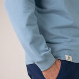 Closeup image of Ocean Meets Green men's golf hoodie Wave in ice, front label