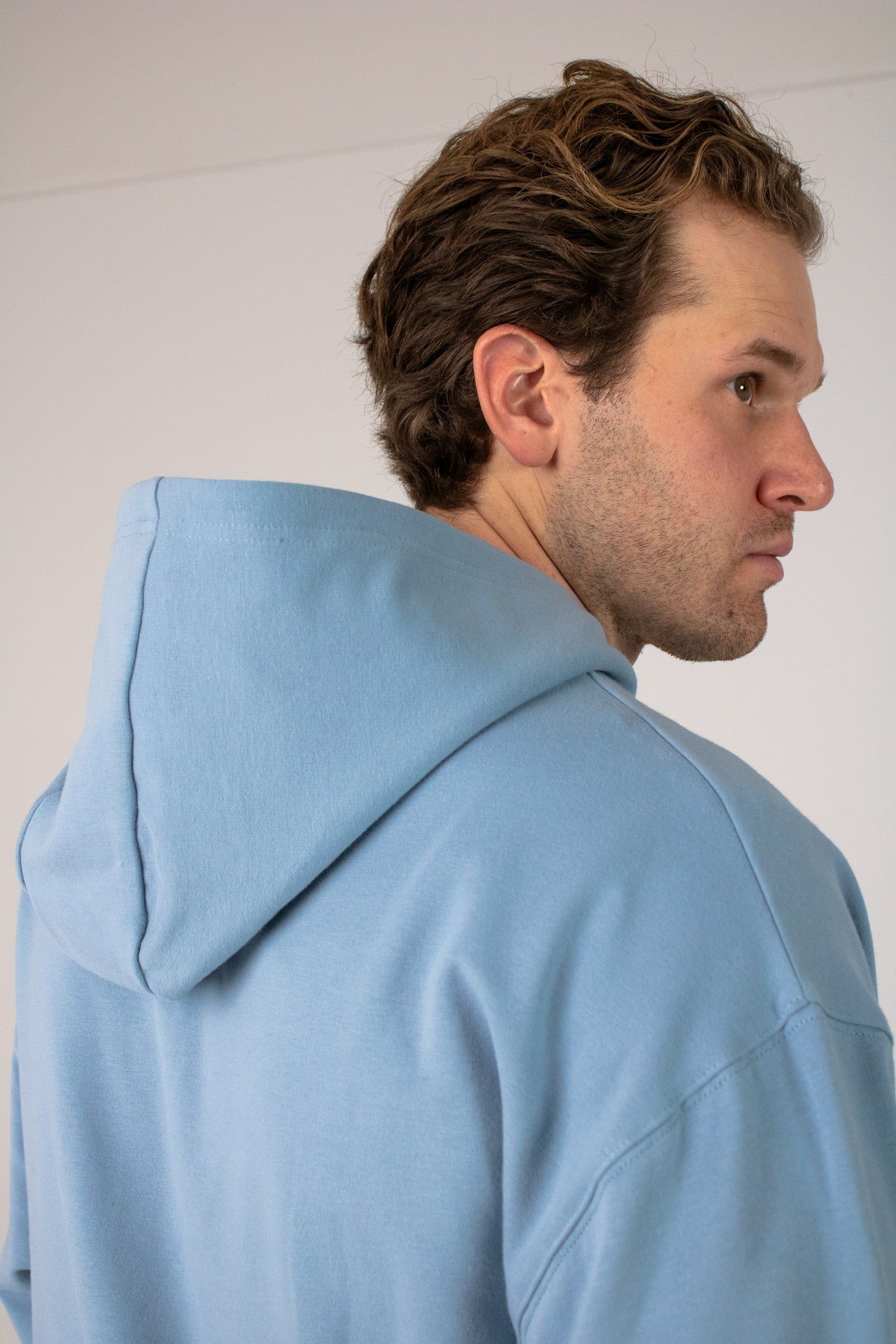 Closeup image of Ocean Meets Green men's golf hoodie Wave in ice