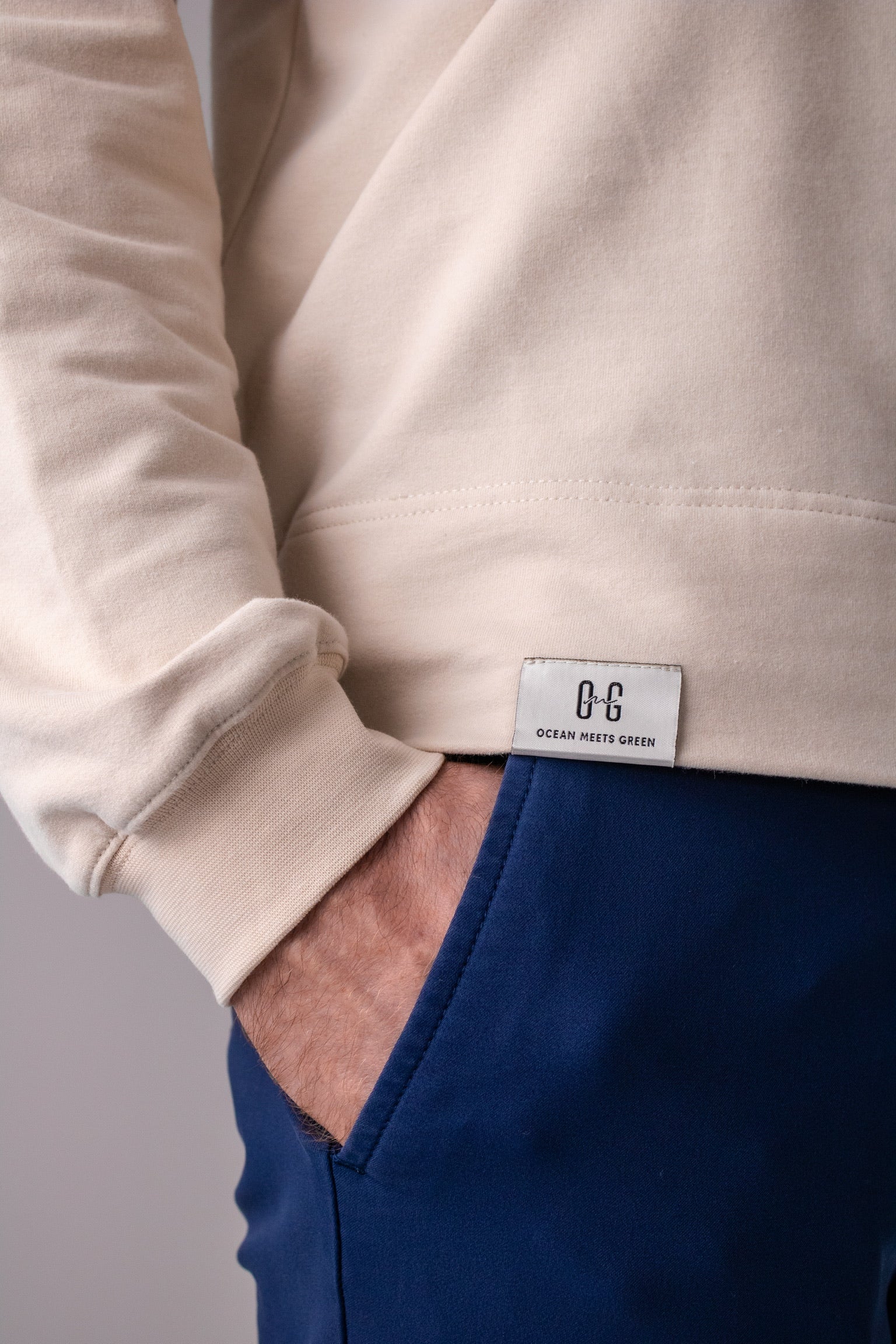 Closeup image of label on Ocean Meets Green men's golf hoodie Wave in sand
