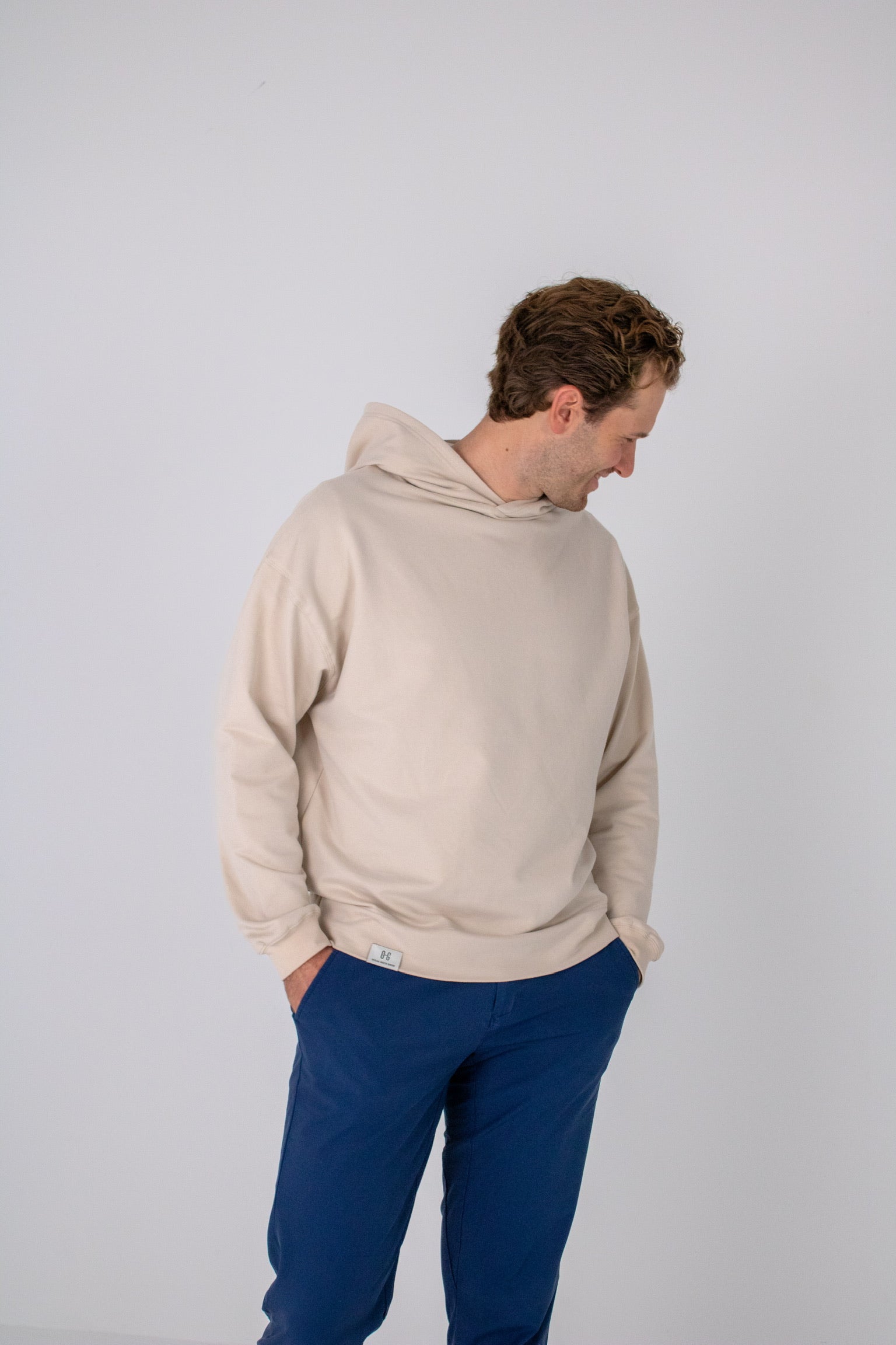 Full body image of Ocean Meets Green men's golf hoodie Wave in sand