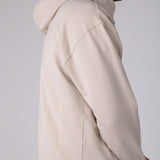 Full body image of Ocean Meets Green men's golf hoodie Wave in sand, showing the logo