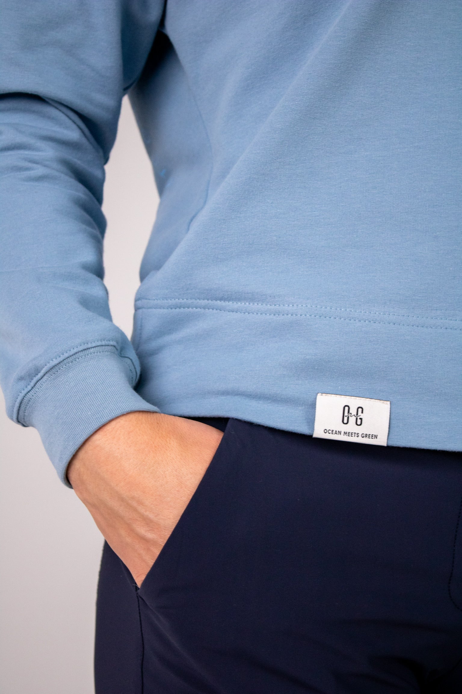 Closeup image of label on Ocean Meets Green women's golf hoodie Flow in ice
