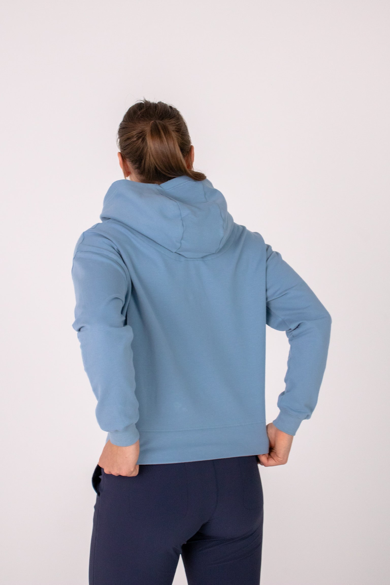 Fullbody image of Ocean Meets Green women's golf hoodie Flow in ice, showing the back