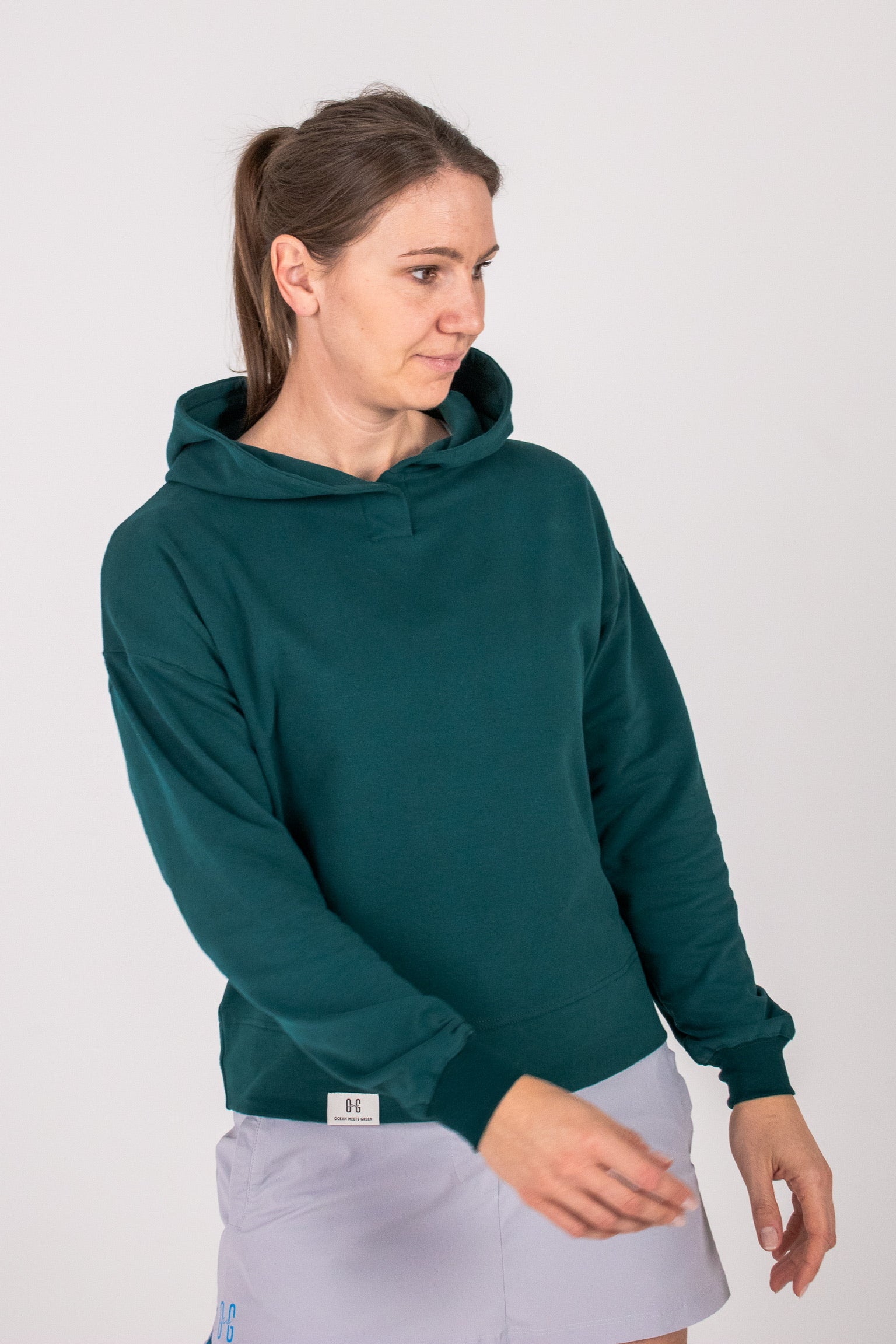 Fullbody image of Ocean Meets Green women's golf hoodie Flow in pine