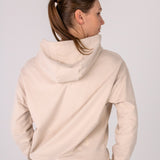 Fullbody image of Ocean Meets Green women's golf hoodie Flow in sand, showing the back