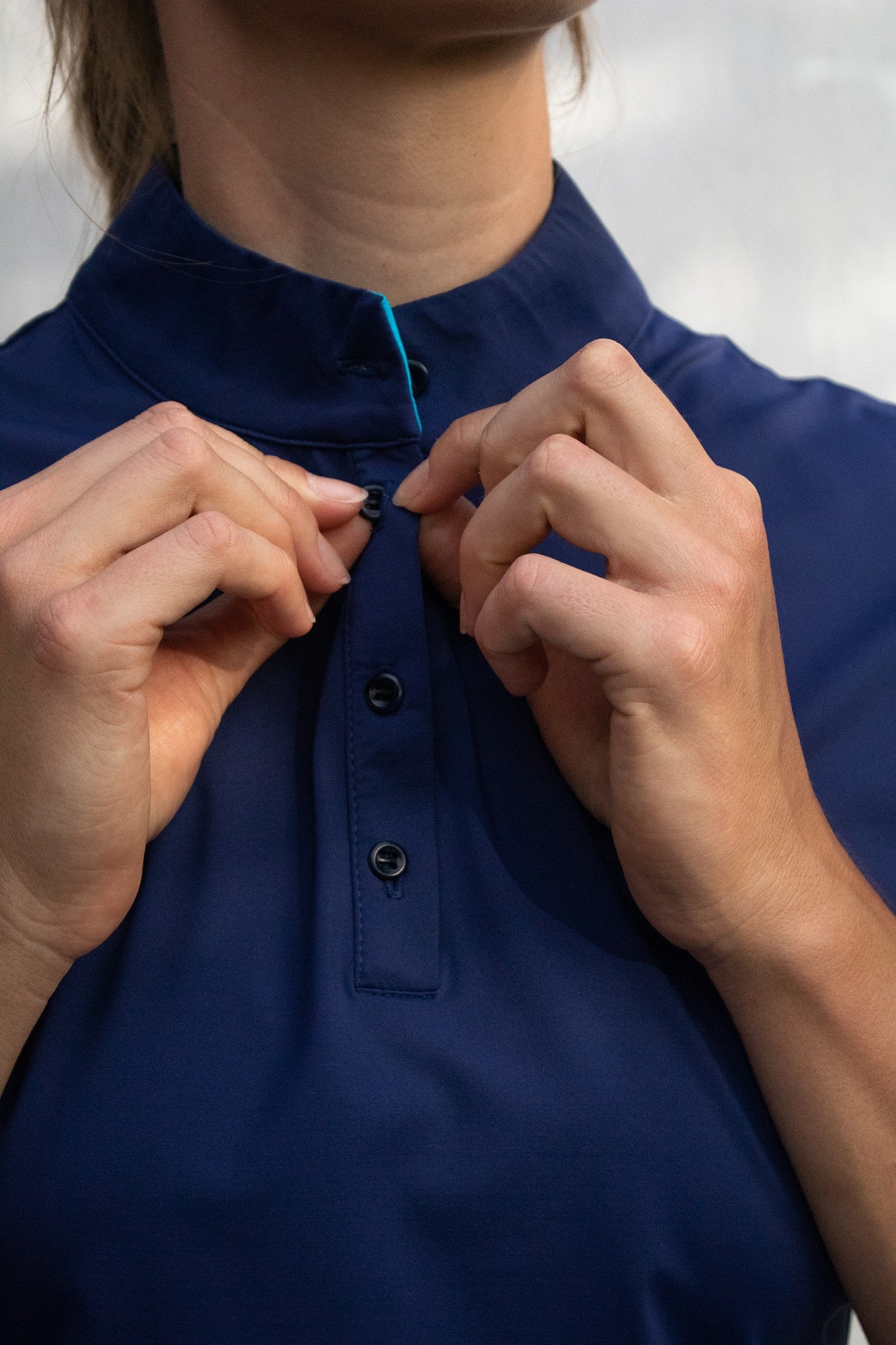 Close-up image of Ocean Meets Green women's golf polo Moana in navy