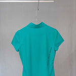 Image of Ocean Meets Green women's golf polo Moana in green on a hanger back view