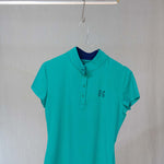 Image of Ocean Meets Green women's golf polo Moana in green on a hanger front view