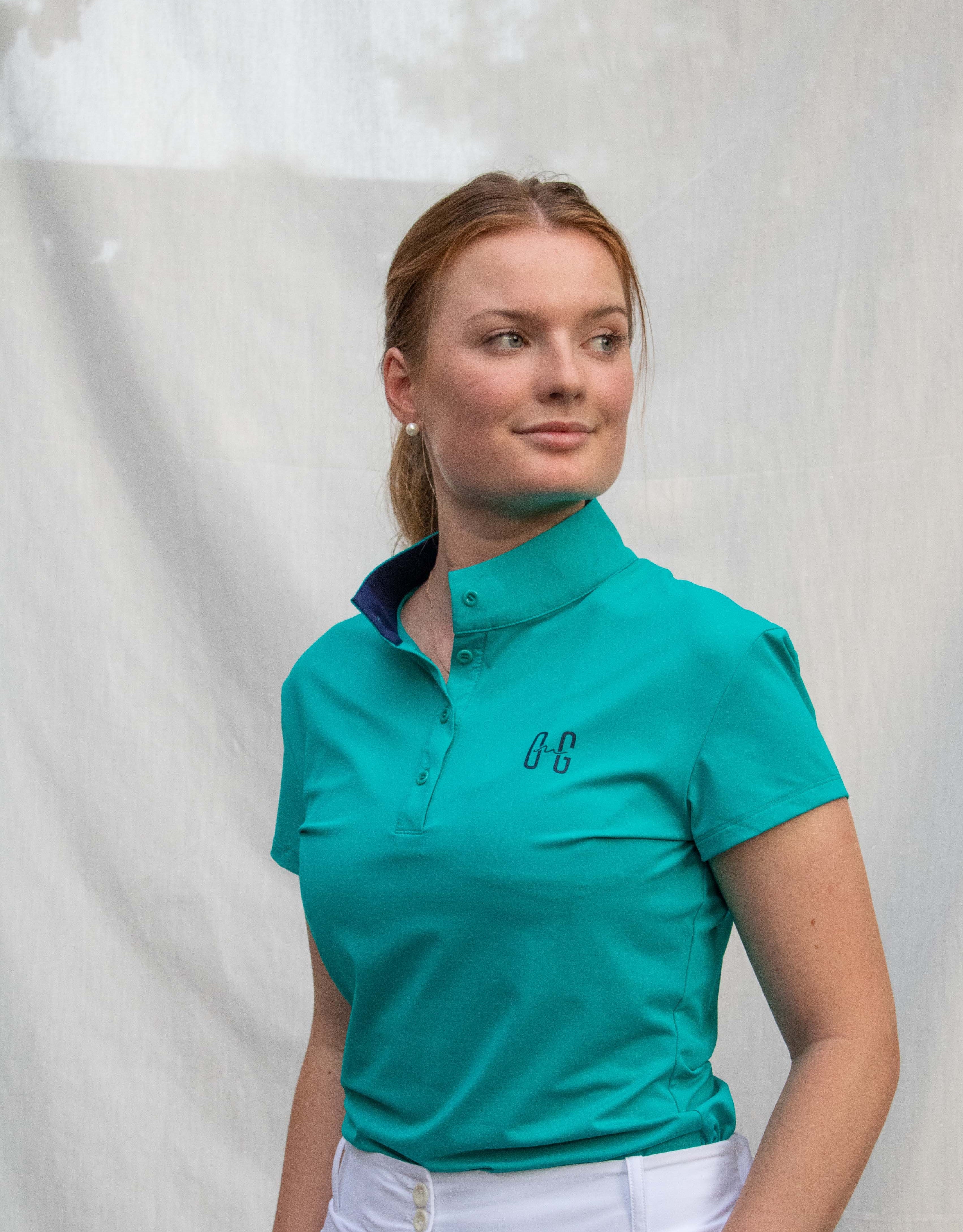 Full body image of Ocean Meets Green women's golf polo Moana in green worn by a woman