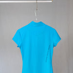 Image of Ocean Meets Green women's golf polo Moana in light blue on a hanger back view