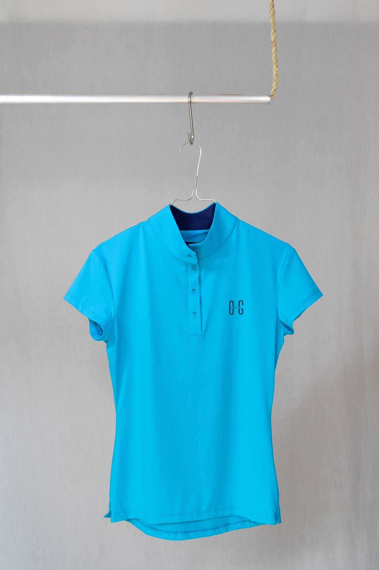 Image of Ocean Meets Green womens golf polo Moana in light blue on a hanger front view