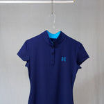 Image of Ocean Meets Green women's golf polo Moana in navy on a hanger front view