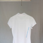 Image of Ocean Meets Green women's golf polo Moana in white on a hanger back view