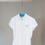 Image of Ocean Meets Green women's golf polo Moana in white on a hanger front view