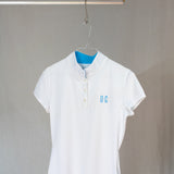 Image of Ocean Meets Green women's golf polo Moana in white on a hanger front view
