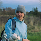 Ocean Meets Green Cloud beanie in grey, fine rib, made from merino wool, worn by a female golfer