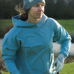 Ocean Meets Green Cloud beanie in grey, fine rib, made from merino wool, worn by a female golfer on the tee