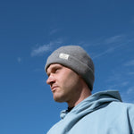 Ocean Meets Green Cloud beanie in grey, made from merino wool, worn by a male golfer