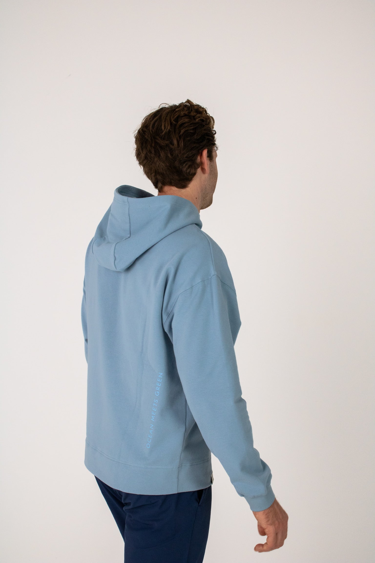 Full body image of Ocean Meets Green men's golf hoodie Wave in ice, showing the logo