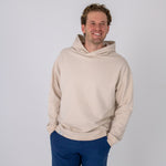 Full body image of Ocean Meets Green men's golf hoodie Wave in sand