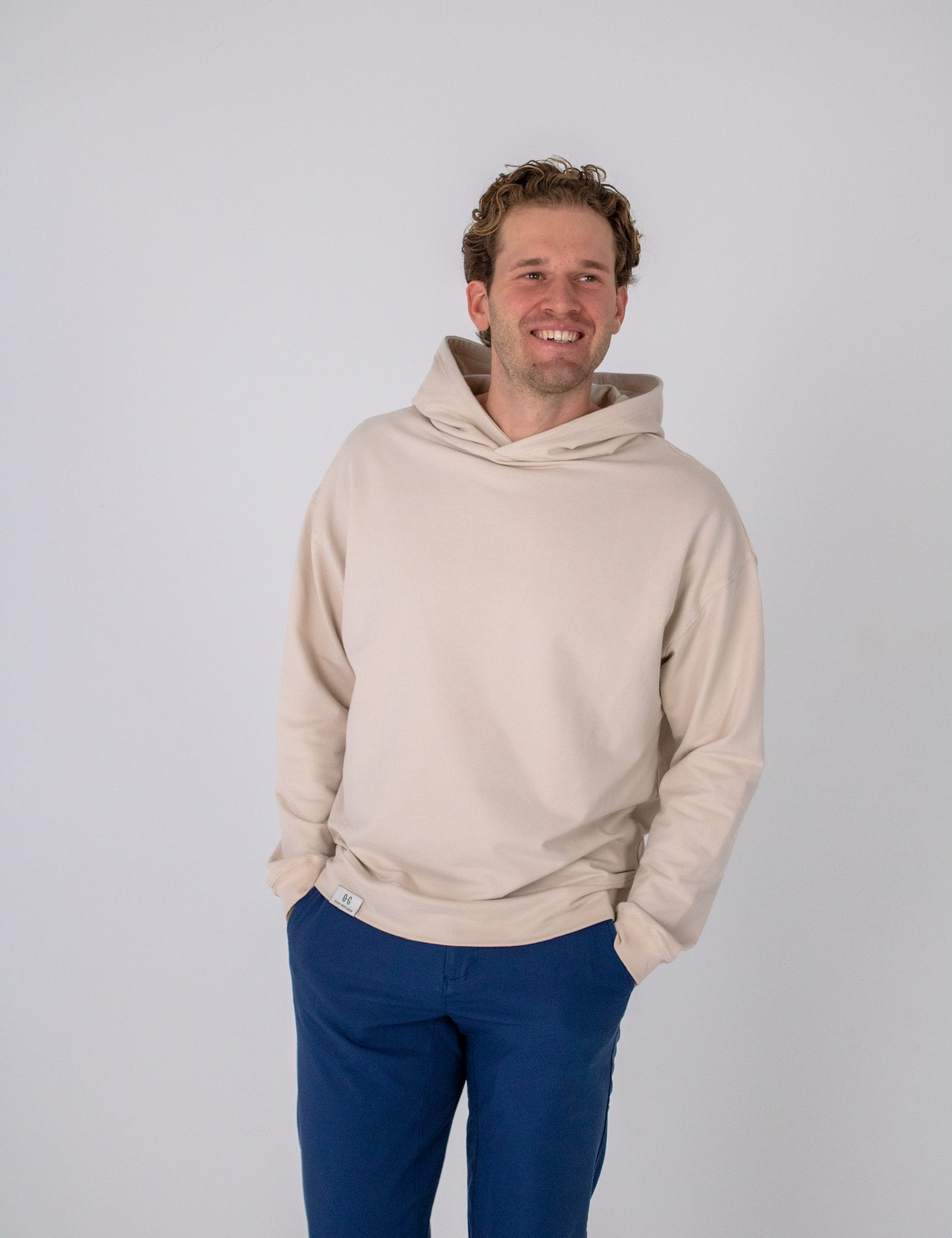 Full body image of Ocean Meets Green men's golf hoodie Wave in sand