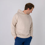 Full body image of Ocean Meets Green men's golf hoodie Wave in sand