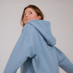 Fullbody image of Ocean Meets Green women's golf hoodie Flow in ice, oversized look