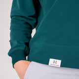 Closeup image of label on Ocean Meets Green women's golf hoodie Flow in pine