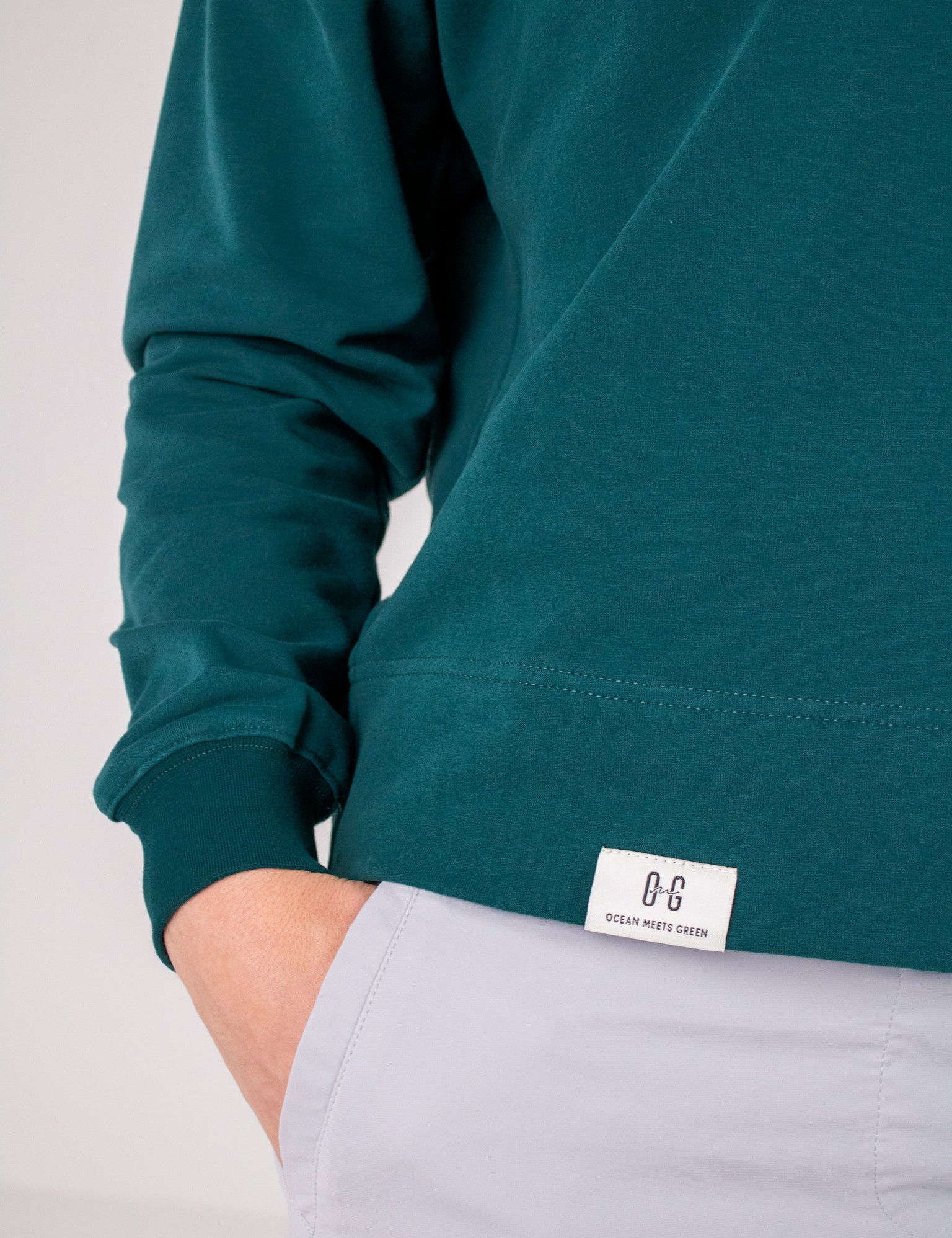 Closeup image of label on Ocean Meets Green women's golf hoodie Flow in pine