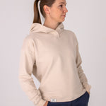 Fullbody image of Ocean Meets Green women's golf hoodie Flow in sand