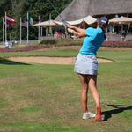 Image of woman wearing the Ocean Meets Green TIDE skirt in grey and the MOANA poloshirt in light blue