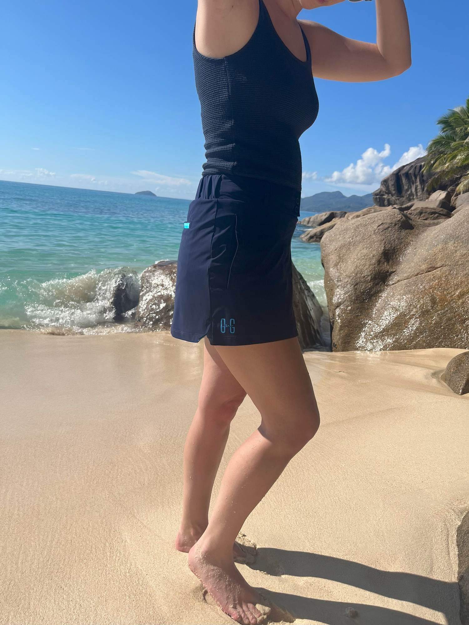 Image of woman wearing Ocean Meets Green Tide skirt in navy on the beach