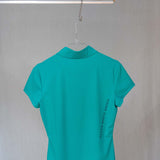 Image of Ocean Meets Green women's golf polo Moana in green on a hanger back view