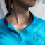 Image of Ocean Meets Green women's golf polo Moana in light blue, showing the standup collar and front logo