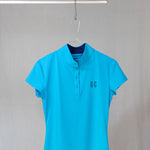 Image of Ocean Meets Green womens golf polo Moana in light blue on a hanger front view