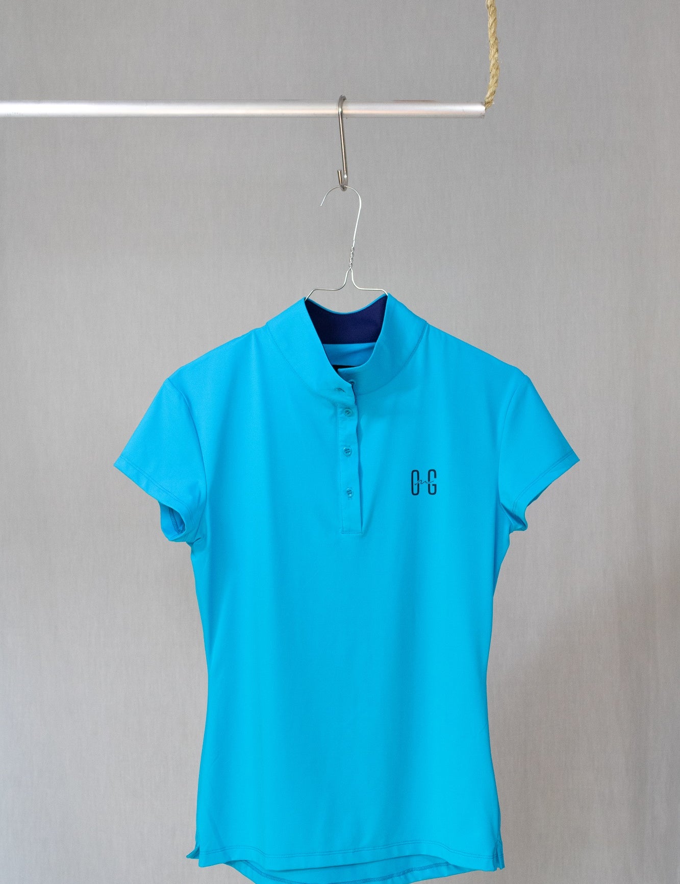 Image of Ocean Meets Green womens golf polo Moana in light blue on a hanger front view