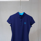 Image of Ocean Meets Green women's golf polo Moana in navy on a hanger front view