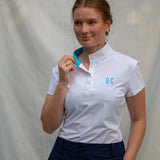Full body image of Ocean Meets Green women's golf polo Moana in white worn by a woman
